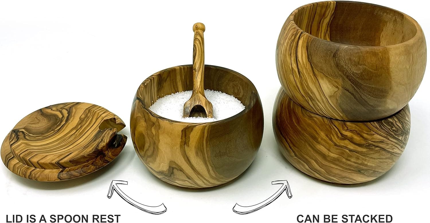 An olive wood salt cellar with its lid used as a spoon rest, and two bowls stacked